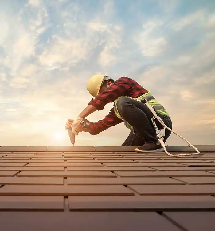 Roofer working at sunrise